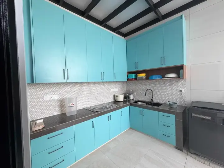 Turquoise kitchen cabinets in the Klang Residence renovation
